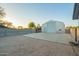 Exterior of a versatile metal garage building with a concrete pad and basketball hoop on a desert lot at 22626 W Gibson Ln, Buckeye, AZ 85326