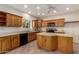 Kitchen with wood cabinets, tile flooring and a sunny window at 22626 W Gibson Ln, Buckeye, AZ 85326