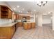Kitchen with wood cabinets, tile flooring and modern appliances at 22626 W Gibson Ln, Buckeye, AZ 85326