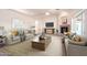 Staged living room featuring modern sofas, a fireplace and decorations at 22626 W Gibson Ln, Buckeye, AZ 85326