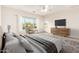 Comfortable main bedroom features neutral tones, natural light, and a ceiling fan at 22626 W Gibson Ln, Buckeye, AZ 85326