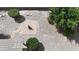 Landscaped backyard featuring a brick firepit, gravel, and mature trees, creating a serene outdoor space at 2329 E Ebony Dr, Chandler, AZ 85286