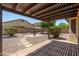 Backyard featuring a covered patio, brick pavers, decorative shrubbery, and a charming fire pit at 2329 E Ebony Dr, Chandler, AZ 85286