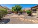 Backyard featuring decorative shrubbery, brick pavers, gravel landscaping and a charming fire pit at 2329 E Ebony Dr, Chandler, AZ 85286