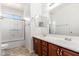 Bathroom featuring a double sink vanity with wood cabinets and a separate shower and toilet room at 2329 E Ebony Dr, Chandler, AZ 85286