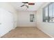 Cozy bedroom with neutral walls, carpet, a modern ceiling fan and a closet behind a white door at 2329 E Ebony Dr, Chandler, AZ 85286
