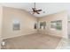 Bright bedroom featuring a vaulted ceiling, a ceiling fan and three large picture windows at 2329 E Ebony Dr, Chandler, AZ 85286