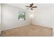 Bright bedroom featuring neutral walls, carpet, a modern ceiling fan and a large window with blinds at 2329 E Ebony Dr, Chandler, AZ 85286