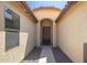 Inviting entryway featuring a dark wood door, arched alcove, and decorative gravel at 2329 E Ebony Dr, Chandler, AZ 85286