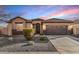 Charming single-story home featuring stone accents, a tile roof, and a two-car garage at 2329 E Ebony Dr, Chandler, AZ 85286