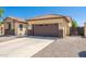 Street view of a well-maintained single-Gathering home with a brown two-car garage and desert landscaping at 2329 E Ebony Dr, Chandler, AZ 85286