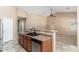 Kitchen island with sink and bar-style countertop, adjacent to the living area at 2329 E Ebony Dr, Chandler, AZ 85286