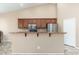 Bright kitchen featuring a breakfast bar with granite countertop and stainless steel appliances at 2329 E Ebony Dr, Chandler, AZ 85286