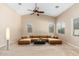 Spacious living room featuring a modern sectional sofa, neutral colors, and natural light through large windows at 2329 E Ebony Dr, Chandler, AZ 85286