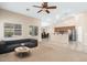 Bright living room showcasing an open floor plan, leading into a dining area and kitchen with stainless steel appliances at 2329 E Ebony Dr, Chandler, AZ 85286