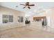 Open-concept living room featuring a ceiling fan, view of the kitchen bar and dining area at 2329 E Ebony Dr, Chandler, AZ 85286