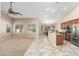 Open-concept living space featuring a ceiling fan, neutral paint, and views of the kitchen and dining area at 2329 E Ebony Dr, Chandler, AZ 85286