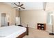 Well-lit main bedroom featuring neutral colors and adjacent bathroom area. Book shelf and large window included at 2329 E Ebony Dr, Chandler, AZ 85286