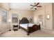 Cozy main bedroom with an ornate bed frame, complemented by soft lighting and an en-suite bathroom at 2329 E Ebony Dr, Chandler, AZ 85286