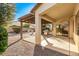 Covered patio with a grill, desert landscaping, and shade for backyard entertaining at 2329 E Ebony Dr, Chandler, AZ 85286