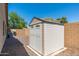 Backyard featuring a storage shed, air conditioner unit, and low-maintenance desert landscaping at 2329 E Ebony Dr, Chandler, AZ 85286