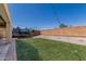 Well-maintained backyard features synthetic grass, white gravel, and a trampoline at 23848 W Grove St, Buckeye, AZ 85326