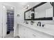 Bright bathroom featuring double sinks, modern fixtures, and a separate toilet and shower space at 23848 W Grove St, Buckeye, AZ 85326