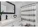 Bright bathroom featuring modern fixtures, black hardware, and neutral decor with a tub and shower combination at 23848 W Grove St, Buckeye, AZ 85326