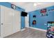 Bedroom features ceiling fan, closet, and blue walls at 23848 W Grove St, Buckeye, AZ 85326
