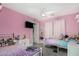 Pink bedroom with ceiling fan, twin beds, and light gray tile flooring offers a cozy and inviting space at 23848 W Grove St, Buckeye, AZ 85326