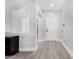 Bright entryway featuring wood-look floors, neutral paint, and an archway leading to other rooms at 23848 W Grove St, Buckeye, AZ 85326