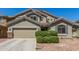 Charming home with a two-car garage, well-maintained landscaping, and desert-style rock ground cover at 23848 W Grove St, Buckeye, AZ 85326