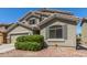 Home exterior showing desert-style rock landscaping, tan paint and a garage at 23848 W Grove St, Buckeye, AZ 85326