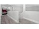 Upstairs hallway with gray wood-look flooring, neutral walls and natural light exudes simplistic sophistication at 23848 W Grove St, Buckeye, AZ 85326