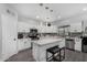 Bright kitchen features a center island with seating, stainless appliances, and white cabinetry at 23848 W Grove St, Buckeye, AZ 85326