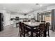 Eat-in kitchen features marble table with seating for eight, pendant lighting, and white cabinetry at 23848 W Grove St, Buckeye, AZ 85326