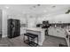 Bright kitchen features a center island with seating, stainless appliances, and white cabinetry at 23848 W Grove St, Buckeye, AZ 85326