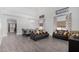 Bright, open-concept living room featuring a dining table, modern furniture, and neutral paint at 23848 W Grove St, Buckeye, AZ 85326
