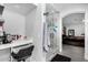Main bathroom features tiled shower, makeup vanity, and view to the main bedroom at 23848 W Grove St, Buckeye, AZ 85326