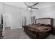 Spacious main bedroom with a ceiling fan, wood-look flooring, and ensuite bathroom with luxurious shower at 23848 W Grove St, Buckeye, AZ 85326