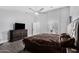 Bright main bedroom features tile floors, ceiling fan, and ensuite bathroom with shower and vanity at 23848 W Grove St, Buckeye, AZ 85326