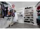 Organized walk-in closet with clothing racks and shoe shelves for storage at 23848 W Grove St, Buckeye, AZ 85326
