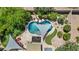 Aerial view of the backyard with pool, lush greenery, shade sails, and outdoor seating at 2585 E Morgan Dr, Gilbert, AZ 85295