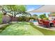 Backyard with putting green, a covered patio with seating, and a view of the beautiful pool at 2585 E Morgan Dr, Gilbert, AZ 85295