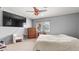 Cozy bedroom featuring a ceiling fan, neutral color palette, and natural light from the window at 2585 E Morgan Dr, Gilbert, AZ 85295