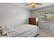 Cozy bedroom featuring neutral colors and a window with wooded views at 2585 E Morgan Dr, Gilbert, AZ 85295