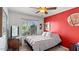 Bedroom with brightly painted wall and window with tree views at 2585 E Morgan Dr, Gilbert, AZ 85295