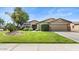 Charming home with a well-manicured lawn, mature trees, and a two-car garage at 2585 E Morgan Dr, Gilbert, AZ 85295