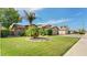 Beautiful home with a well-manicured lawn, mature trees, and a two-car garage at 2585 E Morgan Dr, Gilbert, AZ 85295
