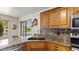 Modern kitchen featuring granite countertops, tile backsplash, and stainless steel appliances at 2585 E Morgan Dr, Gilbert, AZ 85295